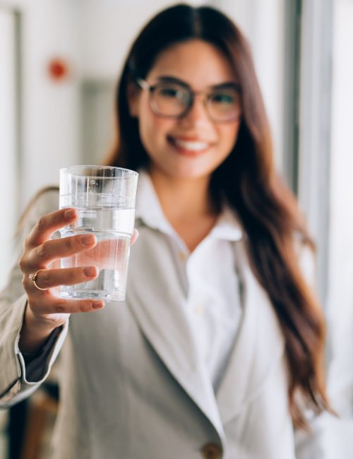 Confident businesswoman with glass at office, Profession female manager drinking water with happiness, High quality photo